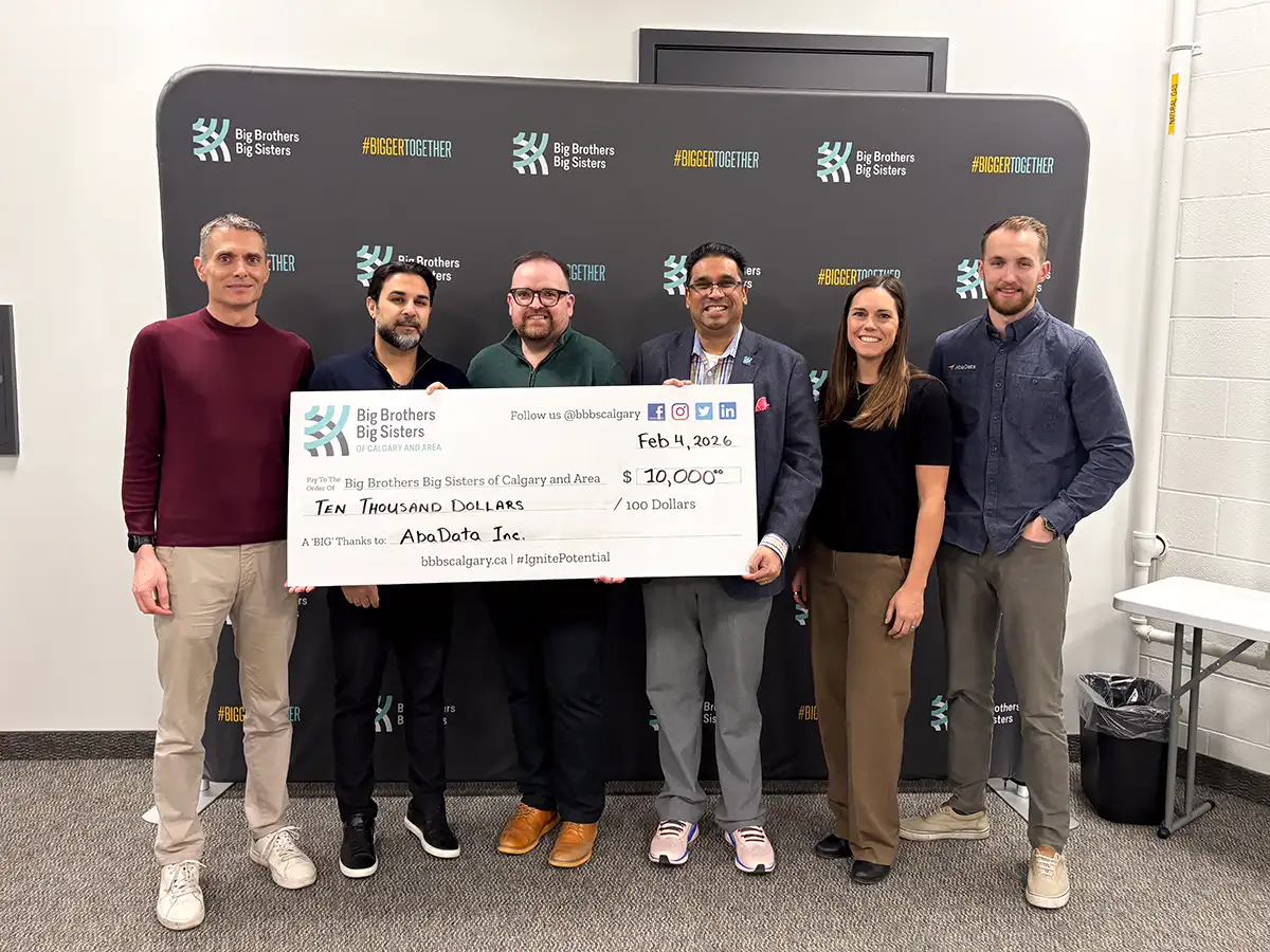 AbaData Charity Cheque Delivery Big Brothers Big Sisters Calgary and Area with AbaData executives handing over a $10,000 cheque to Big Brothers Bis Sisters executives